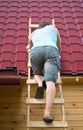 The man climbed the stairs to check the roof of the house after the hurricane