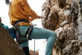 man climber is chalking and clapping hands with white chalk powder before climbing challenging route on cliff