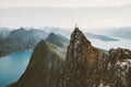 Man climber standing on cliff mountain edge above fjord in Norway