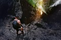 Man climber stands near cave or big rock Royalty Free Stock Photo