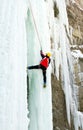 Man climbing frozen waterfall