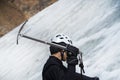 Man is climbing with ice ax on the glacier. Royalty Free Stock Photo