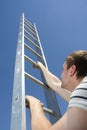 Man climbing ladder Royalty Free Stock Photo