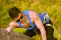 Man climbing mountain with sunglasses Royalty Free Stock Photo