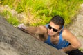 Man climbing mountain with sunglasses Royalty Free Stock Photo