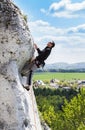 Man climbing natural rocky wall in Poland.
