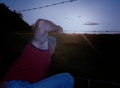 Man climbing over the fence of barbed wire. Escape.. Royalty Free Stock Photo