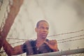 Man climbing over wire fence