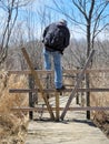 Man Climbing Over Wooden Barrier Royalty Free Stock Photo