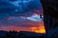 A man is climbing a rock face at sunset generated by AI Royalty Free Stock Photo