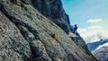 The man is climbing the rock.