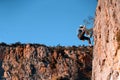 Man is climbing on the rocks in the mountians.