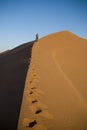 Man climbing sand dune