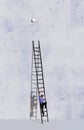A man climbs a ladder on his way to make the annual battery change in smoke alarms