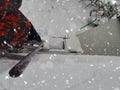 A man climbs a ladder onto a winter roof