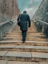 A man climbs the old concrete steps Royalty Free Stock Photo