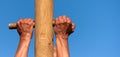 A man climbs onto a pillar