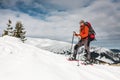 A man climbs to the top of the mountain.