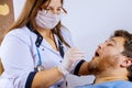 A man in clinical setting being swabbed by a healthcare worker in determine if he has contracted the coronavirus COVID-19 Royalty Free Stock Photo