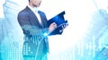 Man with clipboard in city, graph and planet Royalty Free Stock Photo