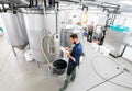 Man with clipboard at craft brewery or beer plant Royalty Free Stock Photo