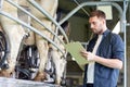 Man with clipboard and milking cows on dairy farm Royalty Free Stock Photo