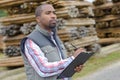 Man with clipboard in woodyard Royalty Free Stock Photo