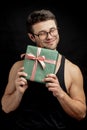 Man with closed eyes is happy to take presents for birthday.