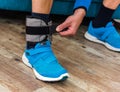 Man closing velcro strap on ankle weight