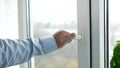 Man Closing a Window from the Office. Shutting Down a Double Glazed Window at Home.