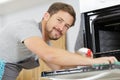 man with cloth cleaning inside oven at home kitchen Royalty Free Stock Photo