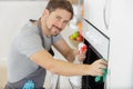 man with cloth cleaning inside oven at home kitchen Royalty Free Stock Photo