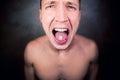 A man without clothes shows his tongue on which lies a pill Royalty Free Stock Photo