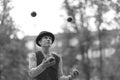 A man clown juggles with small balls