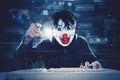 Man in clown mask pointing at cam in binary codes Royalty Free Stock Photo