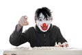 Man in clown mask pointing at cam intimidatingly Royalty Free Stock Photo