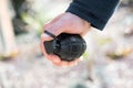 Man clutching a grenade in his hand