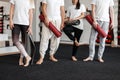 Man coach and women are standing with modern gym mats in hands in a fitness studio. Group stretching, pilates or yoga training. Royalty Free Stock Photo