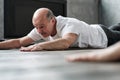 Man in Cobra or sphinx pose bhujangasana variation in the gym Royalty Free Stock Photo