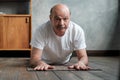 Man in Cobra or sphinx pose bhujangasana variation in the living room. Royalty Free Stock Photo