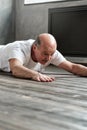 Man in Cobra or sphinx pose bhujangasana variation in the living room Royalty Free Stock Photo