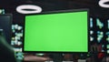 IT man coding green screen pc at datacenter closeup. Developer programming code