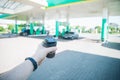 Man with coffee cup going to his car on gas station Royalty Free Stock Photo