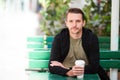 Happy young urban man drinking coffee in european city outdoors Royalty Free Stock Photo