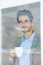 Man, coffee and window with thinking of business ideas, brainstorming or reflection with insight and inspiration Royalty Free Stock Photo