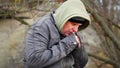 Man cold at outdoors on the bench in the park