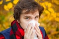 Man with cold rhinitis on autumn background. Fall flu season. Il Royalty Free Stock Photo