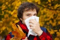 Man with cold rhinitis on autumn background. Fall flu season. Il Royalty Free Stock Photo