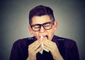 Man with cold sneezing in tissue Royalty Free Stock Photo