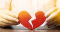 A man collects a red broken heart. Valentine`s Day concept. Love and relationships. Family psychotherapist services.
